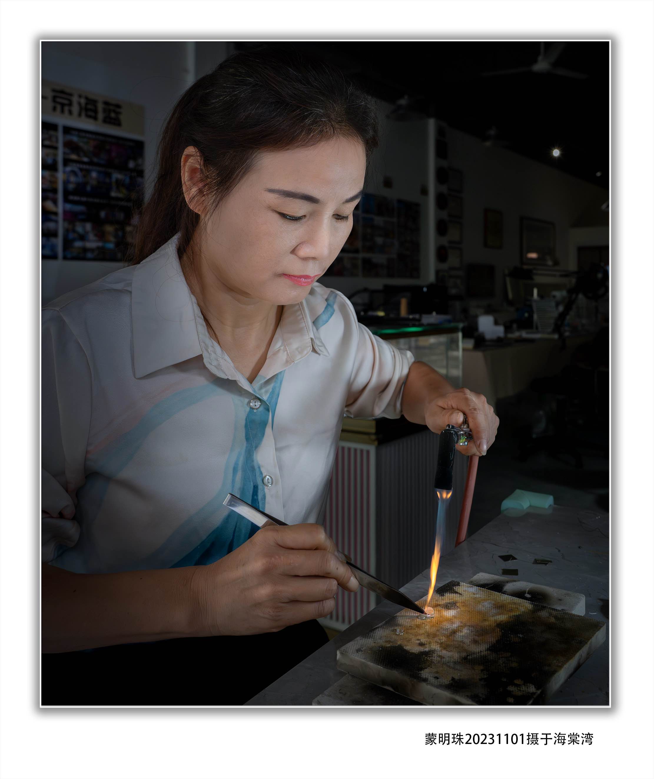 Hu Yan at her workbench, firing enamel with a torch — YÀN Atelier